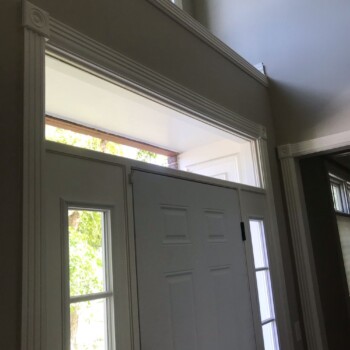 insulated glass window above entry door of home