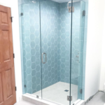 custom frameless shower with blue honeycomb tiles