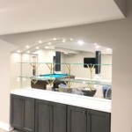 glass shelves on mirror over a wet bar