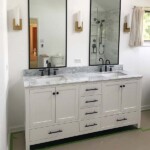 2 mirrors with black framing above bathroom vanity