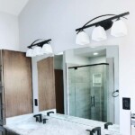 large mirror over bathroom vanity with curved top